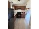 Functional kitchen featuring brown cabinets, black appliances, and efficient storage solutions at 1224 38Th W St, Bradenton, FL 34205