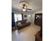 Cozy living room features a comfortable leather sofa, ceiling fan, and plenty of natural light at 1224 38Th W St, Bradenton, FL 34205