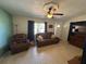 Inviting living room with comfortable brown leather seating and natural light from the window at 1224 38Th W St, Bradenton, FL 34205