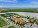 Aerial view of resort-style pool and clubhouse, tennis courts, and lake at 13391 Dimarco St, Venice, FL 34293