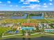 An aerial view of the IslandWalk community clubhouse, pools, and manicured grounds showcases the community's appeal at 13391 Dimarco St, Venice, FL 34293