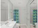 Well-lit bathroom features a shower, sink and toilet at 13391 Dimarco St, Venice, FL 34293