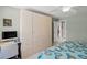 Bright bedroom with a large wardrobe, desk and tiled floors at 13391 Dimarco St, Venice, FL 34293