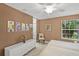 Bedroom features a king bed, window and a dresser with rolling wheels at 13391 Dimarco St, Venice, FL 34293