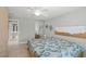 Bedroom featuring a queen bed, tile floors, and ample closet space at 13391 Dimarco St, Venice, FL 34293