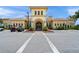 Clubhouse entrance with immaculate landscaping and convenient golf cart parking at 13391 Dimarco St, Venice, FL 34293