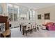 Dining area featuring elegant table and chairs, built-in shelving and seamless transition to living area at 13391 Dimarco St, Venice, FL 34293
