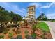 The elegant entrance tower to the community boasts beautiful landscaping and a welcoming fountain feature at 13391 Dimarco St, Venice, FL 34293