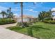 Charming single-story home with a well-manicured lawn, lush landscaping, and a welcoming two-car garage on a sunny day at 13391 Dimarco St, Venice, FL 34293