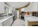 Well-lit kitchen with white cabinets, stainless steel appliances, and ample counter space for food preparation at 13391 Dimarco St, Venice, FL 34293