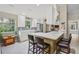 Cozy kitchen with white cabinets, stainless steel appliances, and a breakfast bar illuminated by natural light at 13391 Dimarco St, Venice, FL 34293