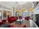 The lounge area features elegant archways, comfortable seating, and a cozy fireplace for relaxed socializing at 13391 Dimarco St, Venice, FL 34293