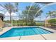 Beautiful screened pool with clear blue water and tropical landscaping at 13391 Dimarco St, Venice, FL 34293