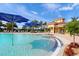 Gorgeous pool area with fountains, umbrellas, and poolside lounge area at 13391 Dimarco St, Venice, FL 34293