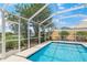 Step into this screened pool with blue tile and convenient access door at 13391 Dimarco St, Venice, FL 34293