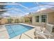 Inviting screened pool area with lounge chairs and lush greenery at 13391 Dimarco St, Venice, FL 34293