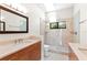 Bathroom with double sinks, a large mirror, and a glass-enclosed shower at 1347 Landings Dr # 6, Sarasota, FL 34231
