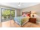 Bedroom with ceiling fan, side table, and balcony access at 1347 Landings Dr # 6, Sarasota, FL 34231