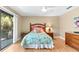 Bedroom with ceiling fan, a side table, and balcony access at 1347 Landings Dr # 6, Sarasota, FL 34231