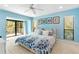 Blue bedroom includes a ceiling fan and access to a deck at 1347 Landings Dr # 6, Sarasota, FL 34231