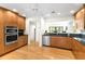 Bright kitchen with wood cabinets, stainless steel appliances, and breakfast bar to the living area at 1347 Landings Dr # 6, Sarasota, FL 34231