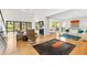 Open-concept living room with high ceilings, fireplace, and access to a private deck at 1347 Landings Dr # 6, Sarasota, FL 34231