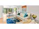 Inviting living room featuring sleek furniture, vibrant artwork, and sliding glass doors leading to the outdoors at 1347 Landings Dr # 6, Sarasota, FL 34231