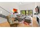 Living room area featuring a sectional couch, hardwood floors, fireplace, and sliding glass doors at 1347 Landings Dr # 6, Sarasota, FL 34231