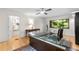 Home office with modern glass desk, bookcase, and natural light from the window at 1347 Landings Dr # 6, Sarasota, FL 34231