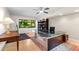 Bright home office with a modern glass desk, bookcase, and large window views at 1347 Landings Dr # 6, Sarasota, FL 34231