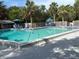 Community pool surrounded by lush landscaping and lounge chairs at 1347 Landings Dr # 6, Sarasota, FL 34231
