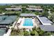 Aerial view showcases a large swimming pool with lounge chairs, umbrellas, and lush landscaping in a desirable waterfront community at 1347 Landings Dr # 6, Sarasota, FL 34231