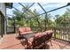 Relax on this inviting screened porch featuring comfortable seating and views of lush tropical landscaping at 1347 Landings Dr # 6, Sarasota, FL 34231