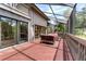 View of the covered lanai with wood floors, seating area and access to the home's interior through sliding glass doors at 1347 Landings Dr # 6, Sarasota, FL 34231