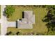 Aerial view of modern home, showcasing the roof, driveway, green lawn, and surrounding trees at 1532 Maricopa Rd, North Port, FL 34287