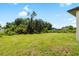 Large backyard with mature trees providing privacy and a serene setting at 1532 Maricopa Rd, North Port, FL 34287