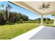 Inviting backyard with lush green grass and covered patio featuring ceiling fan at 1532 Maricopa Rd, North Port, FL 34287