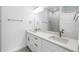 Bathroom featuring double sink vanity, framed mirrors, and marble tile shower at 1532 Maricopa Rd, North Port, FL 34287