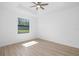 Bright bedroom with a ceiling fan and a large window offering natural light and scenic outdoor views at 1532 Maricopa Rd, North Port, FL 34287
