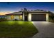 Charming one-story home featuring a two-car garage, neutral color palette, and well-manicured lawn with paver driveway at 1532 Maricopa Rd, North Port, FL 34287