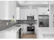 Modern kitchen features stainless steel appliances, stylish cabinets, and an island, combining style and functionality at 1532 Maricopa Rd, North Port, FL 34287