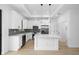 Modern kitchen featuring stainless steel appliances, a center island, and white cabinets at 1532 Maricopa Rd, North Port, FL 34287
