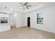 Bright living room features a ceiling fan, recessed lights, wood-look flooring, and a door for easy access at 1532 Maricopa Rd, North Port, FL 34287