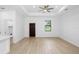 Bright living room features a ceiling fan, recessed lights, wood-look flooring, and a door for easy access at 1532 Maricopa Rd, North Port, FL 34287
