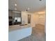 Stylish kitchen featuring an island with a sink, stainless steel appliances, and an adjacent dining area at 16048 Ivy Ridge Ct, Port Charlotte, FL 33953
