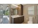 Modern bathroom with a glass shower, neutral tones, vanity storage, and outdoor access at 1627 Peregrine Point Ct, Sarasota, FL 34231
