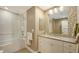 Modern bathroom with a glass shower, neutral tile, and a vanity with ample storage space at 1627 Peregrine Point Ct, Sarasota, FL 34231