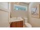 Modern half bathroom featuring a floating vanity, elegant fixtures, and natural light from above at 1627 Peregrine Point Ct, Sarasota, FL 34231