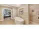 Modern bathroom with a soaking tub, walk-in shower, and tile floors at 1627 Peregrine Point Ct, Sarasota, FL 34231