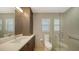 Contemporary bathroom with a glass-enclosed shower, neutral tones, and vanity storage at 1627 Peregrine Point Ct, Sarasota, FL 34231